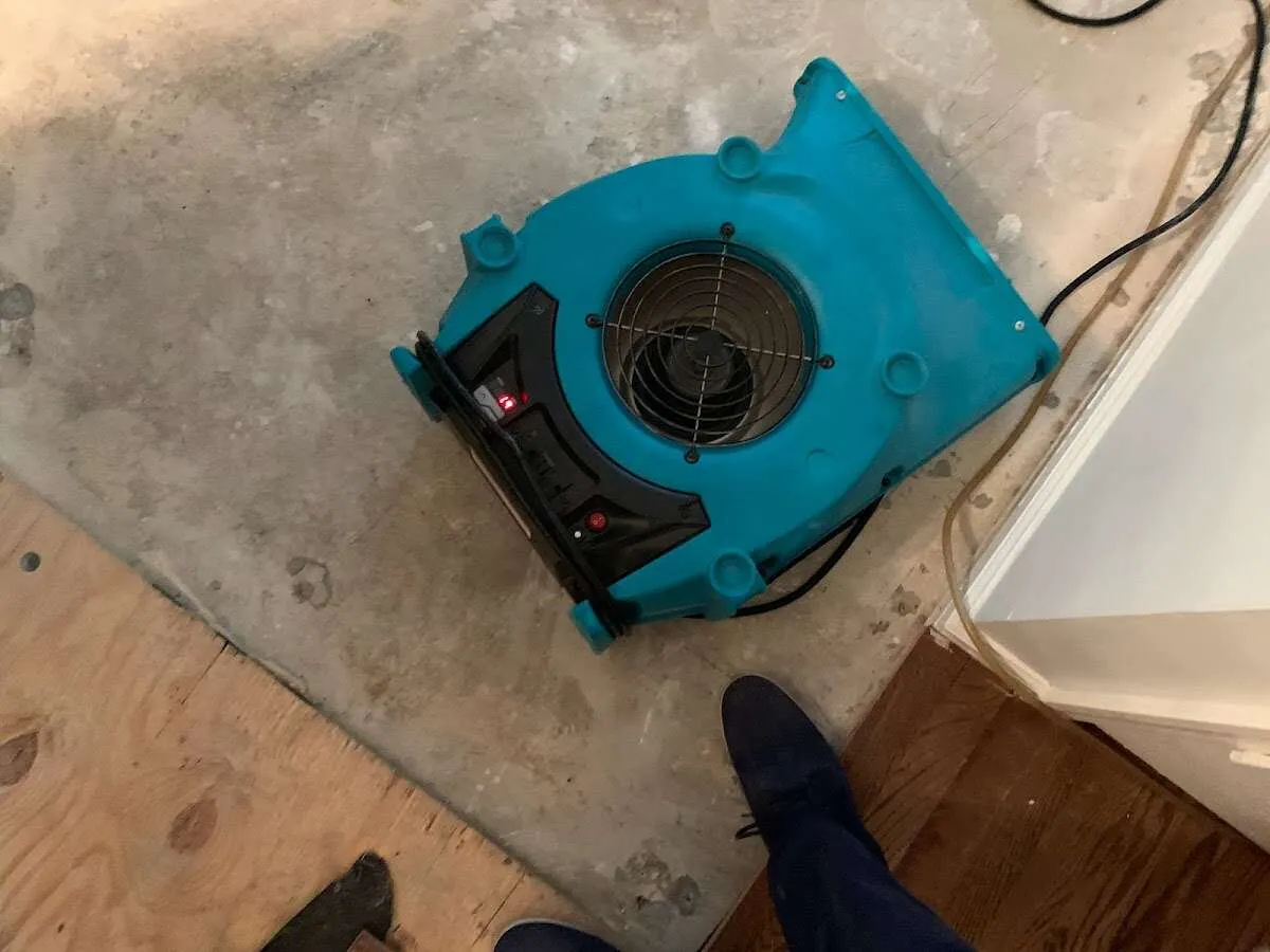 Air mover drying subfloor during Commercial Water Damage Restoration in Ocean Pointe